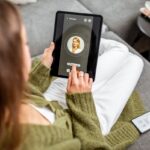 Woman making video call to a doctor using digital tablet, feeling bad at home. Concept of telemedicine and patient counseling online Woman making video call to a doctor using digital tablet, feeling bad at home. Concept of telemedicine and patient counseling online