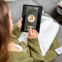 Woman making video call to a doctor using digital tablet, feeling bad at home. Concept of telemedicine and patient counseling online