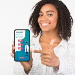 Girl holding phone with online medical services on screen Girl holding phone with online medical services on screen