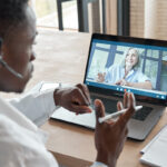 Black male doctor consulting senior patient by telemedicine online video call. Black male doctor consulting senior patient by telemedicine online video call.