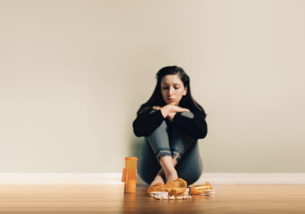 Caucasian female contemplating take prescription pills