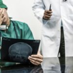 Doctor covering his face with hand. Doctor covering his face with hand.
