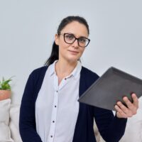 Business woman talking online using video call on digital tablet