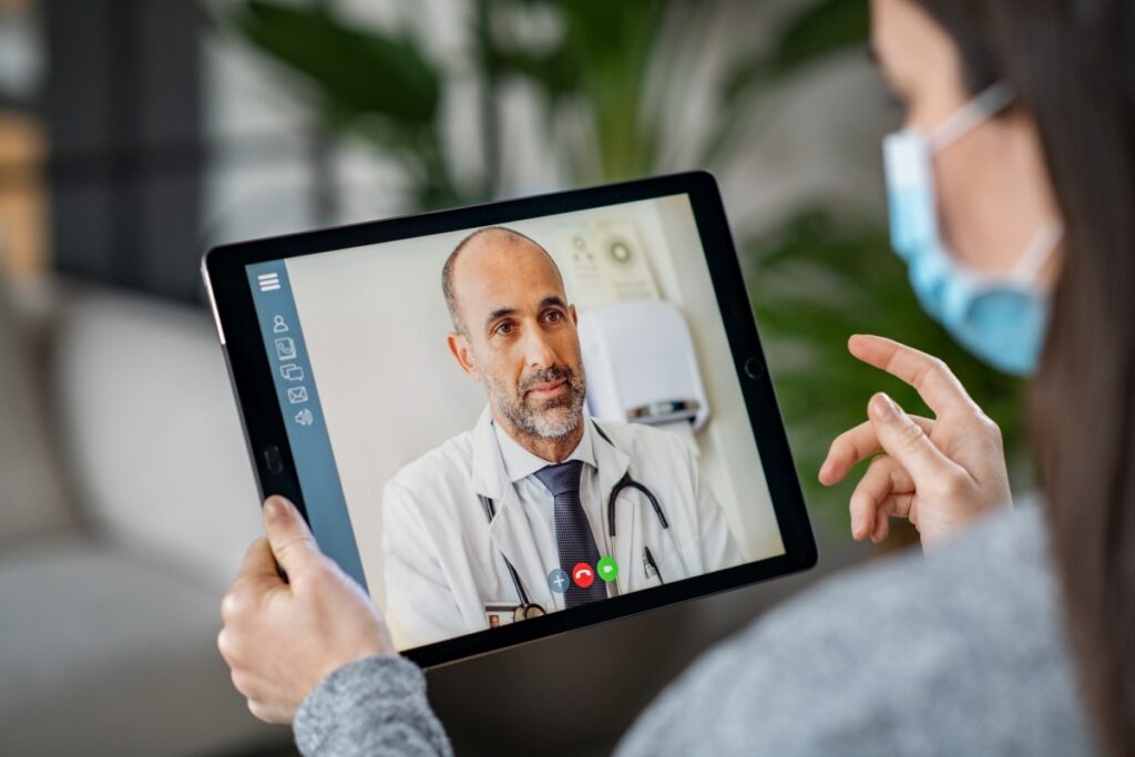 Sick patient in video conference with doctor