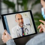 Sick patient in video conference with doctor