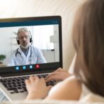 Girl communicating distantly with doctor using webcamera and laptop Girl communicating distantly with doctor using webcamera and laptop