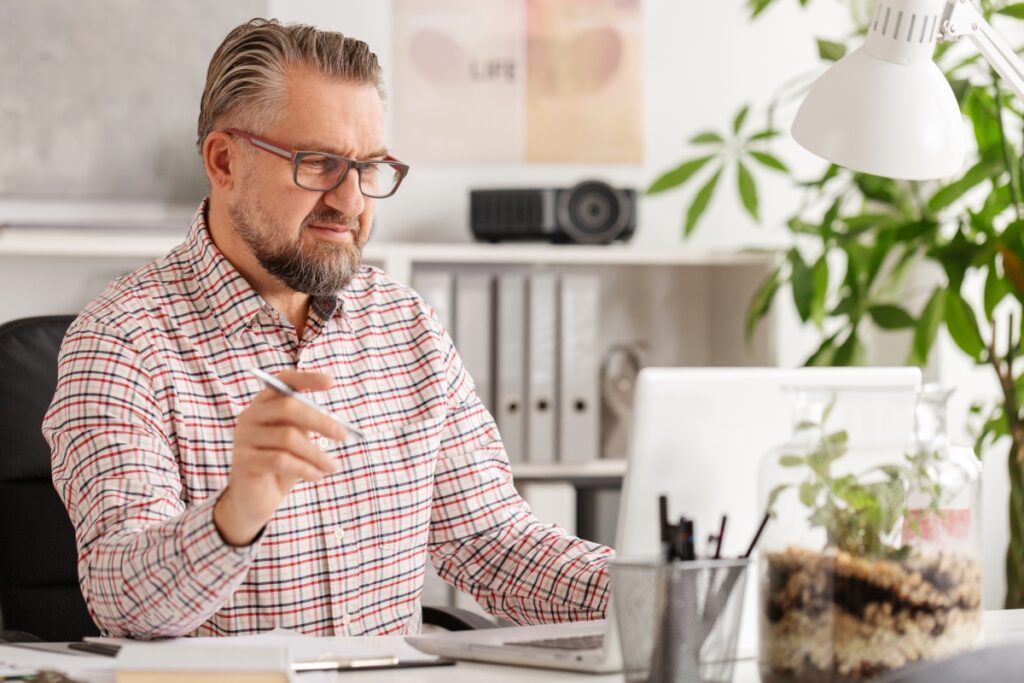 Casual looking handsome corporate manager at his office