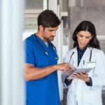Doctor and nurse discussing report Doctor and nurse discussing report